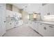 Bright open kitchen with white cabinets and appliances and durable tile flooring at 570 Cypress Ave, Orange City, FL 32763