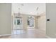 Bright living room with high ceilings, decorative light fixtures, and tile flooring at 570 Cypress Ave, Orange City, FL 32763