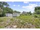 The expansive backyard features mature trees, offering shade and privacy at 570 Cypress Ave, Orange City, FL 32763