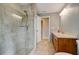 This well-lit bathroom features a walk-in shower with glass door and tile floors at 65 Sycamore Cir, Ormond Beach, FL 32174