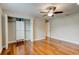 This bedroom features hardwood floors, a ceiling fan, and a closet system at 65 Sycamore Cir, Ormond Beach, FL 32174