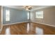Bedroom featuring hardwood floors, ceiling fan, and two large windows at 65 Sycamore Cir, Ormond Beach, FL 32174