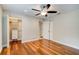 This bedroom features hardwood floors, a ceiling fan, and a built in closet system at 65 Sycamore Cir, Ormond Beach, FL 32174