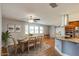 Dining area with hardwood floors and a view of kitchen with stainless steel appliances and granite island at 65 Sycamore Cir, Ormond Beach, FL 32174