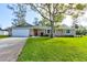Charming single Gathering home featuring a large front yard and a two-car garage at 65 Sycamore Cir, Ormond Beach, FL 32174