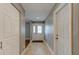 Hallway featuring tile floors and a white front door with glass inserts at 65 Sycamore Cir, Ormond Beach, FL 32174