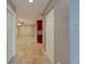 Hallway showcasing neutral paint colors, tile flooring, and closet space at 65 Sycamore Cir, Ormond Beach, FL 32174