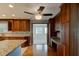 Kitchen with custom wood cabinets, granite countertops, stainless appliances, and open access to the living area at 65 Sycamore Cir, Ormond Beach, FL 32174