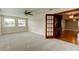 Living room featuring new carpet, ceiling fan, and access to a separate kitchen area at 65 Sycamore Cir, Ormond Beach, FL 32174