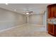 Bright, open living space featuring tile floors, ceiling fan, and sliding glass doors at 65 Sycamore Cir, Ormond Beach, FL 32174