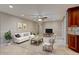 Bright, open living space featuring tile floors, ceiling fan, and neutral paint colors at 65 Sycamore Cir, Ormond Beach, FL 32174