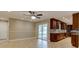 Open floor plan showcasing tile floors, sliding glass doors, and cherry cabinets at 65 Sycamore Cir, Ormond Beach, FL 32174
