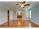 Main bedroom featuring hardwood floors, ceiling fan, and an attached bathroom with a vanity at 65 Sycamore Cir, Ormond Beach, FL 32174
