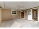 Covered patio with fan, lighting, and access to the main home at 65 Sycamore Cir, Ormond Beach, FL 32174