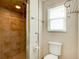 This bathroom features an enclosed tiled walk-in shower and a window at 65 Sycamore Cir, Ormond Beach, FL 32174