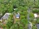 Aerial view of property surrounded by mature trees, showcasing its privacy and location at 658 Westchester Dr, Deland, FL 32724