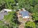 Overhead view of house with brick patio, white picket fence and lush landscaping at 658 Westchester Dr, Deland, FL 32724