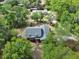 Aerial view of the home with lush greenery surrounding the property and nearby houses at 658 Westchester Dr, Deland, FL 32724
