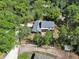 Scenic aerial view of property featuring mature trees and brick patio at 658 Westchester Dr, Deland, FL 32724