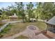 Expansive backyard features a brick fire pit, white picket fence, and mature trees at 658 Westchester Dr, Deland, FL 32724