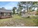Backyard featuring a utility shed and screened porch at 658 Westchester Dr, Deland, FL 32724
