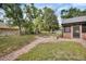 This backyard features a brick pathway and a fire pit at 658 Westchester Dr, Deland, FL 32724
