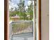 View from balcony showing a house with a brick facade and surrounded by trees at 658 Westchester Dr, Deland, FL 32724