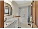 Bathroom featuring a marble countertop, tile shower, and wood trim details at 658 Westchester Dr, Deland, FL 32724