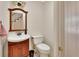 This bathroom features a wood vanity, framed mirror, and tiled floors at 658 Westchester Dr, Deland, FL 32724