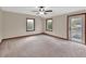 Bright bedroom featuring soft carpet, large windows, and a private outdoor entrance at 658 Westchester Dr, Deland, FL 32724