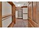 Walk-in closet with custom shelving and ample storage space, lit by modern lighting at 658 Westchester Dr, Deland, FL 32724