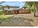 Two-story brick home featuring a red front door and a well-maintained yard at 658 Westchester Dr, Deland, FL 32724