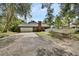 Charming brick home featuring an attached garage and a quaint white picket fence at 658 Westchester Dr, Deland, FL 32724