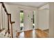 Inviting foyer with hardwood floors, side windows, and decorative molding framing the doorway, welcoming you into this home at 658 Westchester Dr, Deland, FL 32724