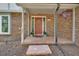 Inviting front porch with brick paving, planters, and red door at 658 Westchester Dr, Deland, FL 32724