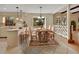 Open concept kitchen area with breakfast bar seating adjacent to a dining area and a view of the backyard at 658 Westchester Dr, Deland, FL 32724