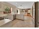 Open-concept kitchen features white cabinets, a tile floor, a view of the Gathering room, and stainless-steel appliances at 658 Westchester Dr, Deland, FL 32724