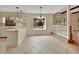 Bright, open-concept kitchen/dining area with tile flooring, pendant lighting, and natural light from the garden view at 658 Westchester Dr, Deland, FL 32724