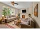 Cozy living room with neutral tones, fireplace, and large windows at 658 Westchester Dr, Deland, FL 32724