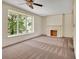 Bright living room featuring a large window and fireplace at 658 Westchester Dr, Deland, FL 32724