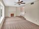 Spacious living room with a fireplace and access to another room at 658 Westchester Dr, Deland, FL 32724