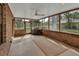 Relaxing screened porch area with brick accents and ceiling fan at 658 Westchester Dr, Deland, FL 32724