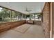 Screened porch with brick accents and neutral rug at 658 Westchester Dr, Deland, FL 32724