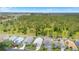 Community aerial showcasing the home in a neighborhood surrounded by natural green space at 824 Casterton Cir, Davenport, FL 33897
