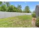Lush green backyard featuring a well-maintained lawn and privacy fence at 824 Casterton Cir, Davenport, FL 33897