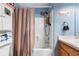 Cozy bathroom with a shower and tub combination and blue accent wall at 824 Casterton Cir, Davenport, FL 33897
