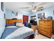 Bright bedroom with blue walls and a ceiling fan, plus space for gaming at 824 Casterton Cir, Davenport, FL 33897