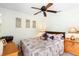 A relaxing bedroom featuring a ceiling fan and calming artwork at 824 Casterton Cir, Davenport, FL 33897