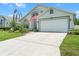 Charming single-Gathering home with a large driveway, well-manicured lawn, and attached garage at 824 Casterton Cir, Davenport, FL 33897