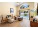Cozy living room featuring hardwood floors, comfortable seating, and sliding glass doors to the pool at 824 Casterton Cir, Davenport, FL 33897